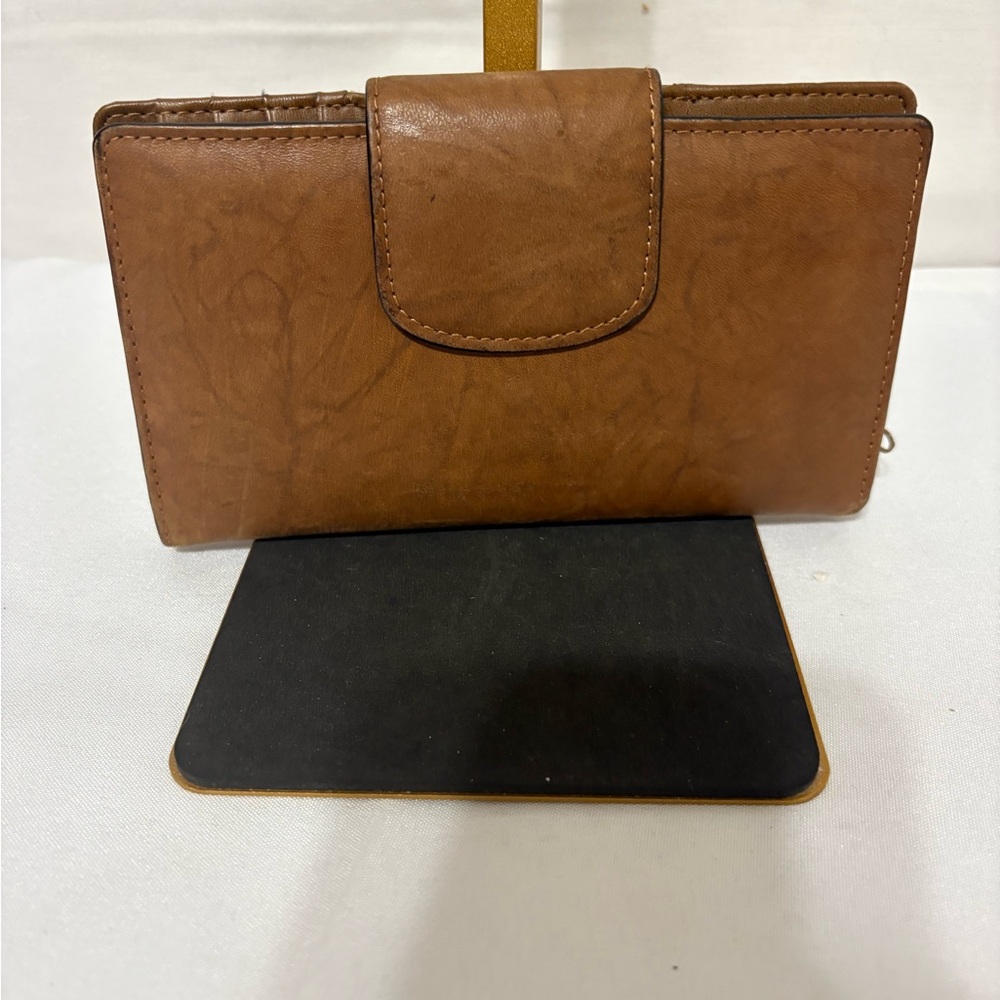 brown leather wallet with an expandable double-snap closure.